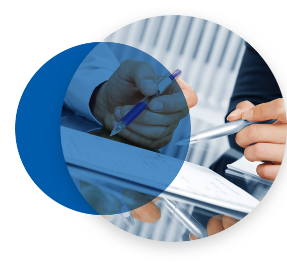 Two people pointing to a document with their pens