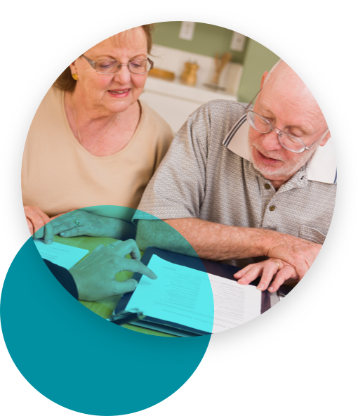 Woman explaining an item in a document to a senior couple