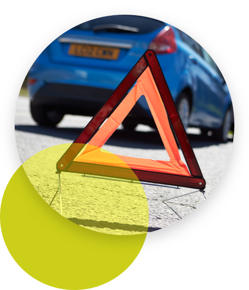 Triangle traffic sign placed behind a car accident