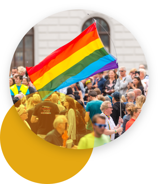 Man with a big rainbow flag in a street crowd