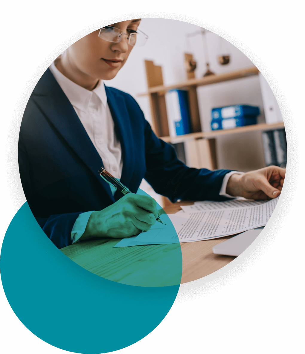 Woman in glasses completing items on a document