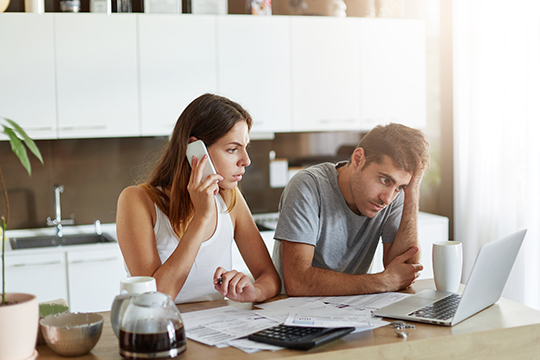 Stressed couple dealing with several documents