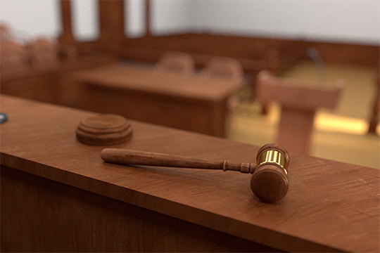 Close up of a gavel in an empty courtroom