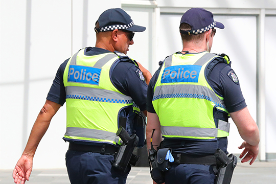 Two Victoria police officers walking side by side