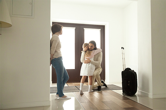 Child hugging her mother who is about to leave