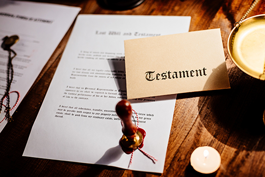 Last will and testament on a table with candles